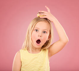 Image showing Child, donut and wow face portrait in studio with hand on head on a pink background. Girl kid model with sweet snack, surprise and shocked or comic expression isolated on creative color and space