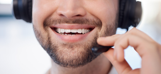 Image showing Man at call center, smile closeup and contact us with customer service employee, face and CRM with consultant. Professional, communication, mouth with headset and mic, help desk and telemarketing