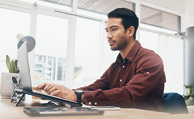 Image showing Business man, laptop and information technology, tech support and serious while working in office. Typing, glitch or 404 with software update, corporate male at desk with digital problem solving