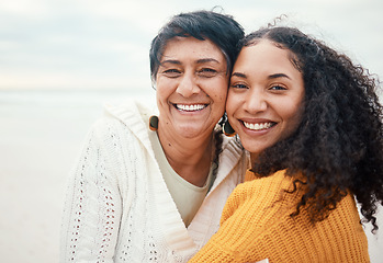 Image showing Happy, hug and portrait of a mother and daughter at the beach for travel, bonding and vacation. Family, smile and elderly mom with an adult woman at the ocean to relax together for happiness