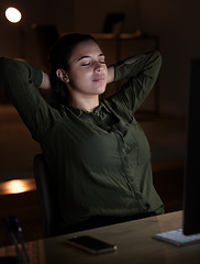 Image showing Night, relax and overtime with a business woman in her office, sitting hands behind head after a late shift. Peace, quiet and calm with a young female resting in the workplace after a deadline