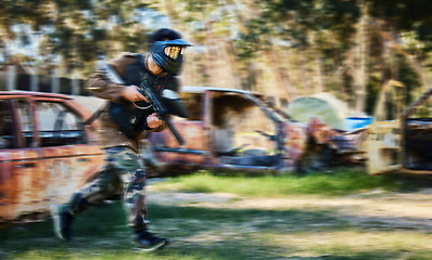 Image showing Man, paintball and rush for intense battle or war in the forest running to attack on grass field. Male paintballer or soldier moving fast to push enemy defense in extreme adrenaline sports outdoors