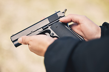 Image showing Weapon, pistol and hands with gun outdoor for police, military and safety training at firing range. Security, danger and person holding metal firearm for criminal protection, shooting and fight crime