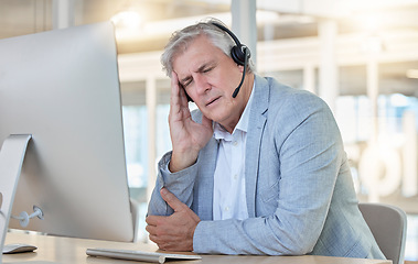 Image showing Call center, customer service and headache with a consultant man suffering from pain while working in the office. Crm, support and burnout with a senior male telemarketing working feeling stress