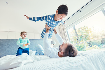 Image showing Love, father and kid in air, bed and quality time on break, happiness or bonding together. Family, dad or lifting boy in bedroom, cheerful or playing with joy, game or freedom with affection or smile