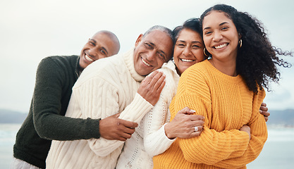 Image showing Portrait, happy family and hug at the beach by siblings with mature parents on holiday, happy and bonding. Face, love and senior couple happy on retirement vacation while embracing adult children