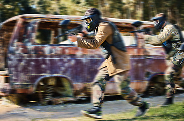 Image showing Paintball, team work or people running in shooting game with speed or fast action on a fun battlefield. Mission focus, blurry caravan or men with guns for survival in competition in nature or forest