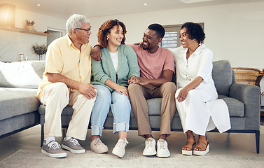 Image showing Happy family, parents and couple relax on a sofa, talking and laughing while bonding in a living room. Woman, man and seniors on a couch, happy and smile while enjoying weekend and retirement at home