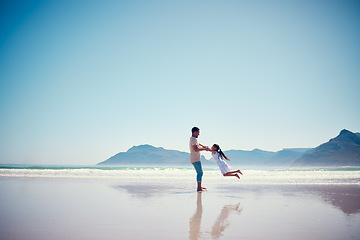 Image showing Mockup, father and daughter playing on the beach together during summer vacation or holiday by the ocean. Sky, sea or view with a man and female child swinging while bonding on the sand at the sea
