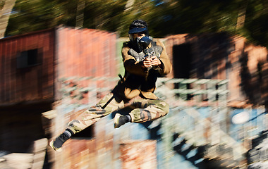 Image showing Blurred, military and man shooting in paintball, army training and fitness test for war. Sports, game and soldier jumping with a gun for battle on a battlefield, playing and competing in games
