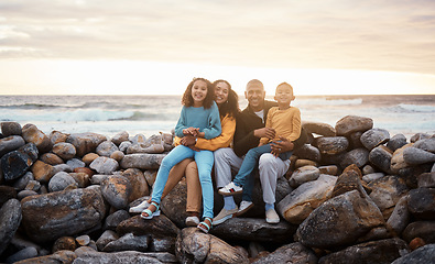 Image showing Black family, parents and children in beach portrait with excited face, sitting and rocks with happiness. Black woman, man and kids by ocean with love hug, care and bonding on holiday by sunset sky