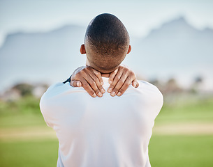 Image showing Neck pain, injury and athlete hurt on sports field at training, fitness and exercise suffering from muscle inflammation. Workout, physical and back view of man in an emergency due to accident