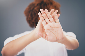 Image showing Closeup, hands and woman in studio for stop, warning or domestic violence symbol on grey background. Zoom, justice and hand of girl in protest, caution and protection, scared and abuse awareness