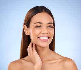 Image showing Portrait, smile and woman with dermatology, cosmetics and grooming against blue studio background. Face, lady and female with happiness, natural and salon treatment for morning routine and soft skin