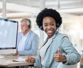 Image showing Happy, portrait and black woman in a call center with a thumbs up for online support and thank you. Smile, success and African customer service worker with an emoji hand gesture for achievement