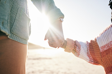 Image showing Family, mother and child holding hands at beach, travel and summer with sunshine lens flare and together outdoor. Trust, support with woman and girl on vacation, love and care in nature with closeup