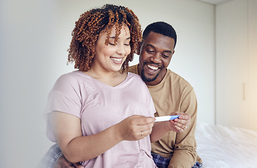 Image showing Couple with pregnancy test results, fertility and people having a baby, happy with love and care at home. Interracial, black man and pregnant woman, start family with new mother and father with smile