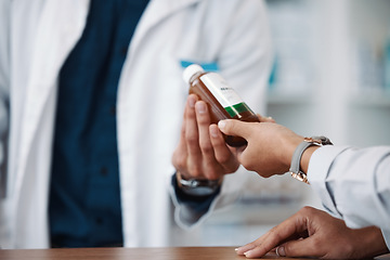 Image showing Hands, bottle or medicine with a pharmacist and customer in a drugstore for prescription treatment. Healthcare, medical or pharmacy with a consultant and patient in a dispensary for insurance