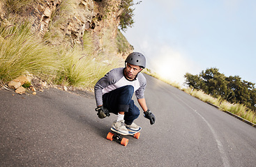 Image showing Skateboard, travel and mountain with man in road for speed, freedom and summer break. Sports, adventure and wellness with guy skating fast in street for training, gen z and balance in nature