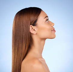 Image showing Face, hair care and beauty profile with woman, keratin treatment with shine on blue background. Skincare, natural cosmetics and mockup, facial and hairstyle, female with smile in studio and skin glow