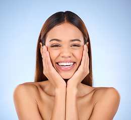 Image showing Skincare, hands on face and portrait of woman laughing in studio for skin care promo on blue background. Makeup, facial cosmetics and smile, hispanic beauty model in Mexico for dermatology promotion.