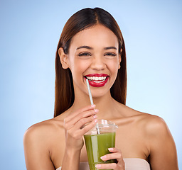 Image showing Beauty, smoothie and health with portrait of woman in studio for detox, nutrition and diet, Happy, smile and minerals with girl model and green juice on blue background for vegan, fiber and protein