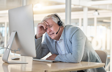 Image showing Call center, customer support and headache with a consultant man suffering from pain while working in the office. Crm, service and burnout with a senior male telemarketing working feeling stress