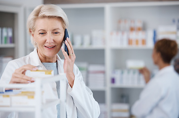 Image showing Pharmacy medicine, pharmacist phone call and woman talking in drugstore for telehealth. Healthcare, smartphone and happy senior medical doctor in consultation for medication prescription in shop.