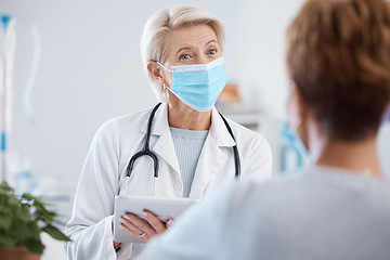 Image showing Tablet, covid doctor and woman consulting in hospital for health and wellness. Healthcare, face mask and patient in consultation with senior medical professional with touchscreen technology in clinic