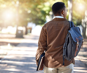 Image showing Black man, walking or backpack on campus, park nature or garden for college, university or school studying development. Student, gen z and person with learning books, education bag or growth mindset