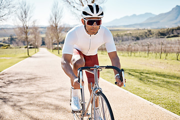 Image showing Man, professional athlete and cycling in nature, park path or exercise training of triathlon sports in Cape Town. Cyclist, bicycle and outdoor bike in summer, fitness challenge and cardio performance