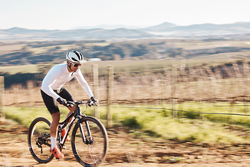 Image showing Man, bike and cycling with motion blur in nature, countryside and training of triathlon, sports or power. Cyclist, bicycle and speed of off road travel, energy and freedom in action, wellness or path