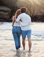 Image showing Back, hug and couple walking, beach and quality time on summer vacation, weekend break and romance. Romantic, man and woman embrace, love and happiness for holiday, journey and adventure together