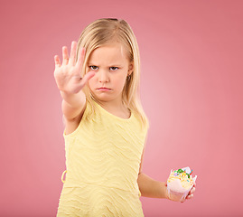 Image showing Stop, angry and child portrait with a no hand gesture and cupcake showing a sharing problem. Conflict, frustrated and serious little girl with a birthday dessert in isolated pink background in studio