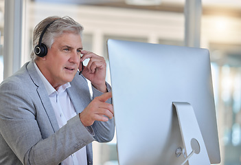Image showing Call center, advice and senior man at computer with headset in consulting in customer service office . Ceo, insurance sales and mature businessman at advisory agency, contact us and crm networking.