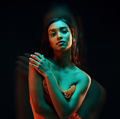 Image showing Green light, fashion and Indian woman with beauty, glowing skin and luxury brand aesthetic. Creative lighting, young female and model with a dark background in a studio with modern style and makeup