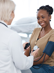 Image showing Blood pressure, doctor and black woman patient smile in hospital for healthcare consulting services. Clinic worker check arm hypertension, diabetes test and heart wellness for healing surgery results