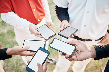 Image showing Hands, phone and communication with a baseball team outdoor on a sport field for strategy or tactics before a game. Teamwork, fitness and networking with a group of people sharing sports information