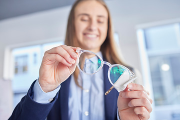 Image showing Hands, glasses and an optometrist woman cleaning lenses in a store to sell a product for fashion. Vision, eyewear and optometry with a female optician wiping a pair of frame eyeglasses for eyesight