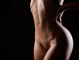 Image showing Nude, sexy woman and stomach for art deco and creative erotic nudity in a studio. Black background, isolated and female model naked feeling seductive, attractive and sensual in the dark with mockup