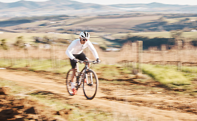 Image showing Man, bicycle and cycling with motion blur in nature, countryside and training for triathlon, sports and power. Cyclist, mountain bike and speed for off road travel, exercise or professional challenge