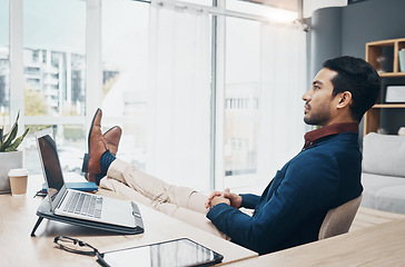 Image showing Office, feet up and businessman working on laptop, thinking and unsure of design or proposal. Unsure, doubt and pensive leader relax while contemplating, brainstorming or deciding mission plan