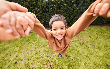 Image showing Playing, happy and portrait of a child swinging with hands from a parent for fun and bonding. Smile, playful and carefree boy kid in a fast swing while holding hands with mom or dad in a garden