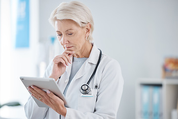 Image showing Healthcare, tablet and senior doctor thinking in hospital for online consulting, telehealth and wellness app. Clinic, medicine and woman on digital tech for internet, medical research or patient data