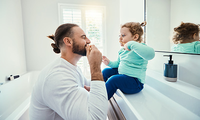 Image showing Family, children or brushing teeth with a father and girl in the bathroom of their home together or dental hygiene. Kids, teaching or oral with man and female child bonding while mouth cleaning