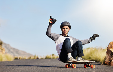 Image showing Skateboard, slide and man in road for sports competition, fitness training and exercise on mountain. Skating, skateboarding and male skater riding for speed, adventure and freedom for sport challenge