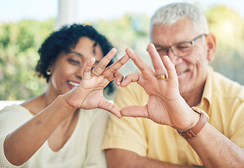 Image showing Senior couple, hands and heart emoji for love, relationship or trust and care in marriage at home. Happy elderly man and woman putting hand together in hearty shape sign, symbol or gesture in romance