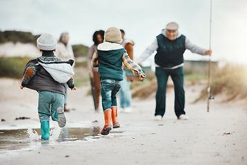 Image showing Happy, running and family at the beach for fishing, freedom and excited about vacation. Smile, greeting and kids at the ocean with grandfather, parents and grandmother to fish during a holiday