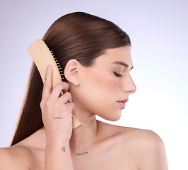 Image showing Hair care, beauty and face of woman with brush in studio isolated on a gray background. Eyes closed, eco friendly and female model with sustainable wooden hairbrush for salon treatment or hairstyle.