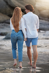 Image showing Couple walking on beach, holding hands and travel with love and commitment in relationship, adventure and romance. Trust, partnership and care with people outdoor, tropical holiday and back view